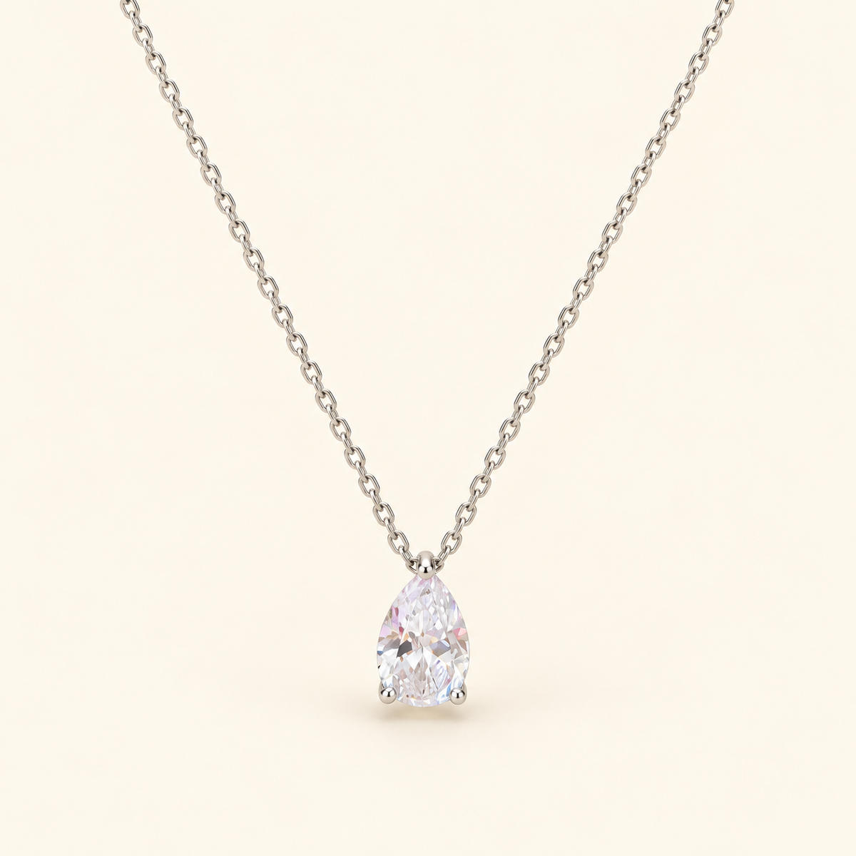 Teardrop pendant necklace on an ivory background