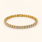Gold-tone bracelet on an ivory background